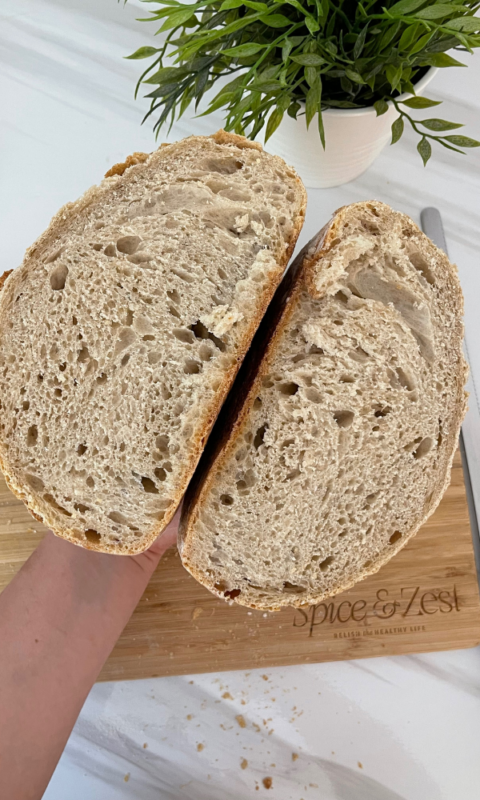 A loaf of white spelt bread cut in half 