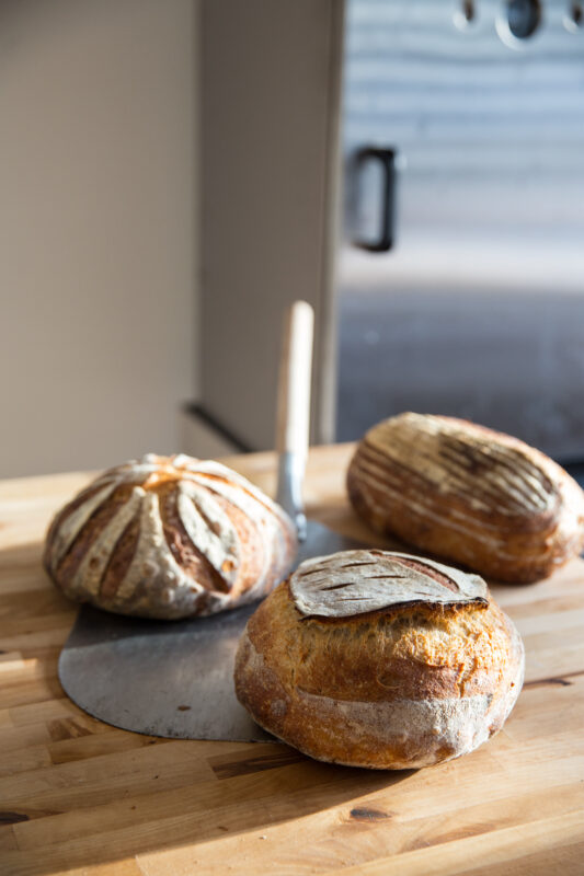 Three baked loaves of sourdough bread 