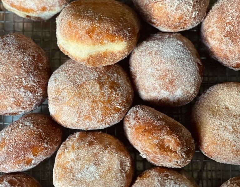 a bunch of freshly fried donuts